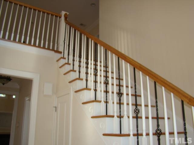3517 Blue Ridge Road Raleigh, NC 27612 - Photo 2 of 16 a view of staircase with railing and a window