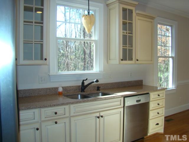3517 Blue Ridge Road Raleigh, NC 27612 - Photo 6 of 16 a kitchen with stainless steel appliances white cabinets and a window
