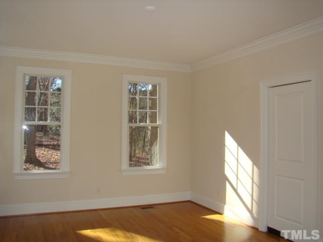 3517 Blue Ridge Road Raleigh, NC 27612 - Photo 7 of 16 a view of a bedroom with wooden floor and a window