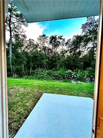 a view of a kitchen with a sink and a refrigerator