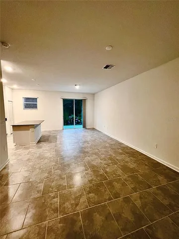 a kitchen with kitchen island granite countertop a sink counter top space appliances and cabinets