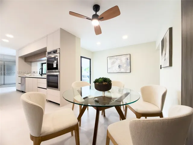 a dining room with furniture and window