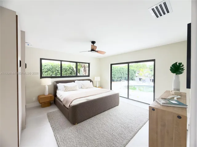 a bedroom with a large bed and a window