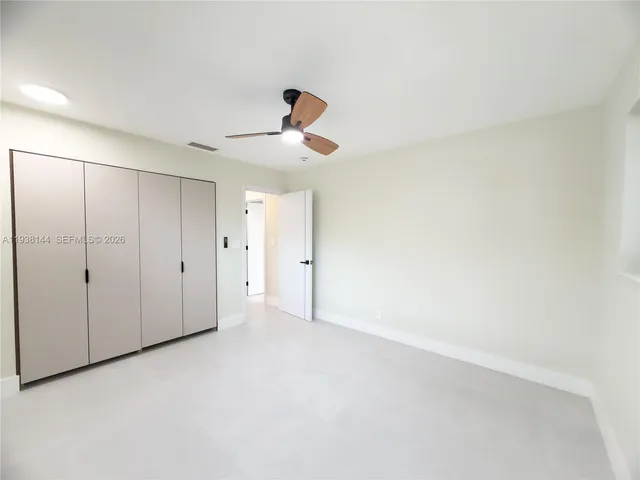 a view of a living room with a ceiling fan