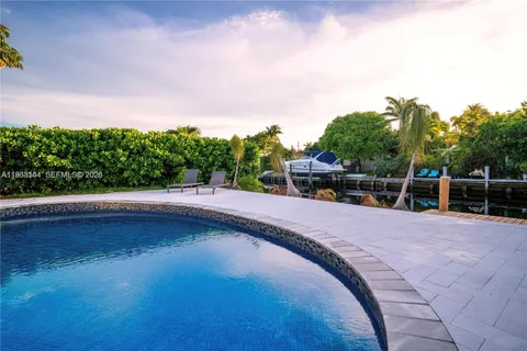 an aerial view of a house with swimming pool garden and patio