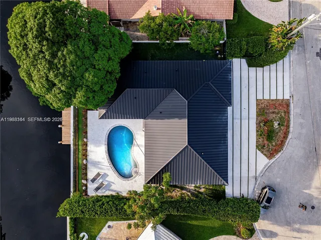 a aerial view of a house with a yard and potted plants
