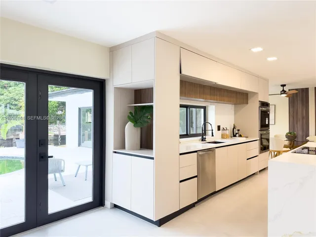 a kitchen with stainless steel appliances granite countertop a stove and a refrigerator