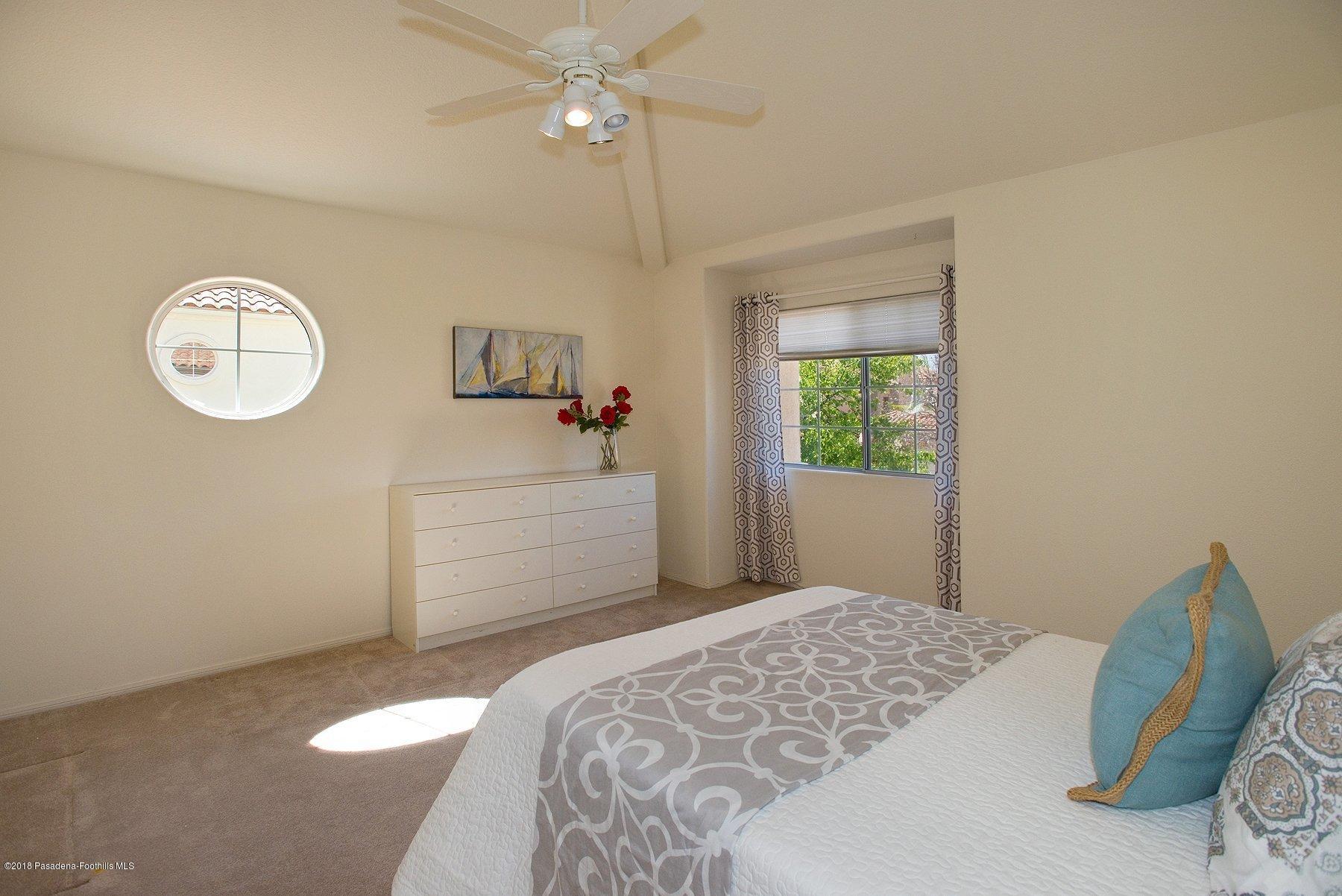 925 C. Amable Glendale, CA 91208 - Photo 19 of 37 a bedroom with a bed and a chandelier