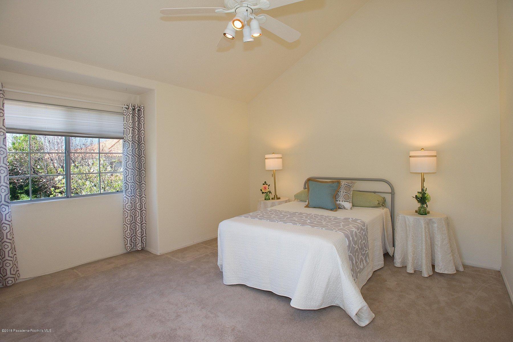 925 C. Amable Glendale, CA 91208 - Photo 20 of 37 a bedroom with a bed and a chandelier