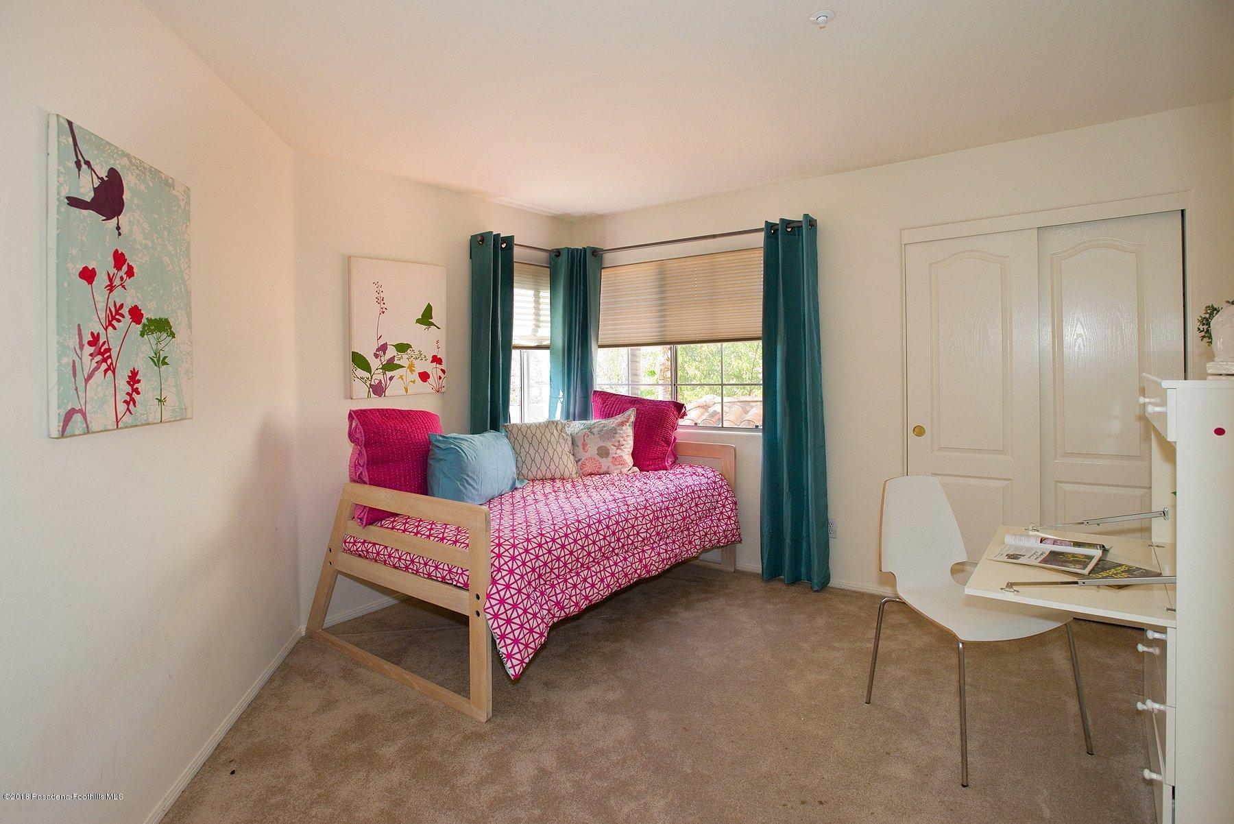 925 C. Amable Glendale, CA 91208 - Photo 24 of 37 a bedroom with a bed and a painting on the wall