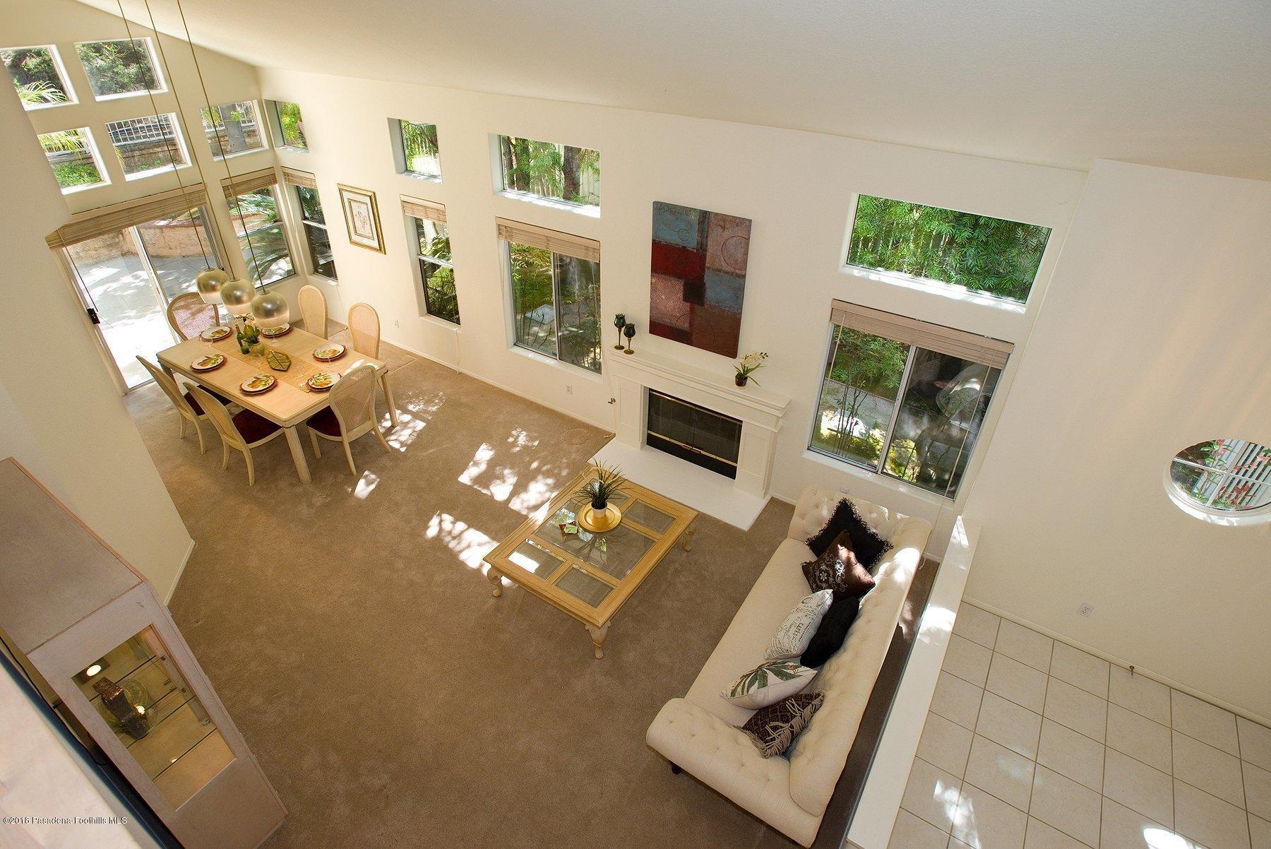 925 C. Amable Glendale, CA 91208 - Photo 26 of 37 a living room with furniture floor to ceiling window and a flat screen tv