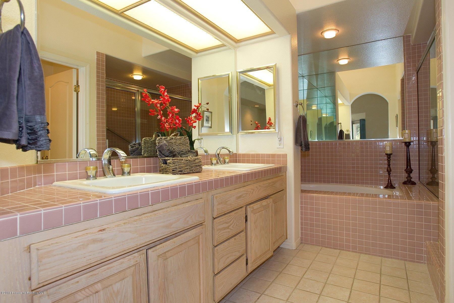 925 C. Amable Glendale, CA 91208 - Photo 29 of 37 a bathroom with a sink a large mirror and a shower