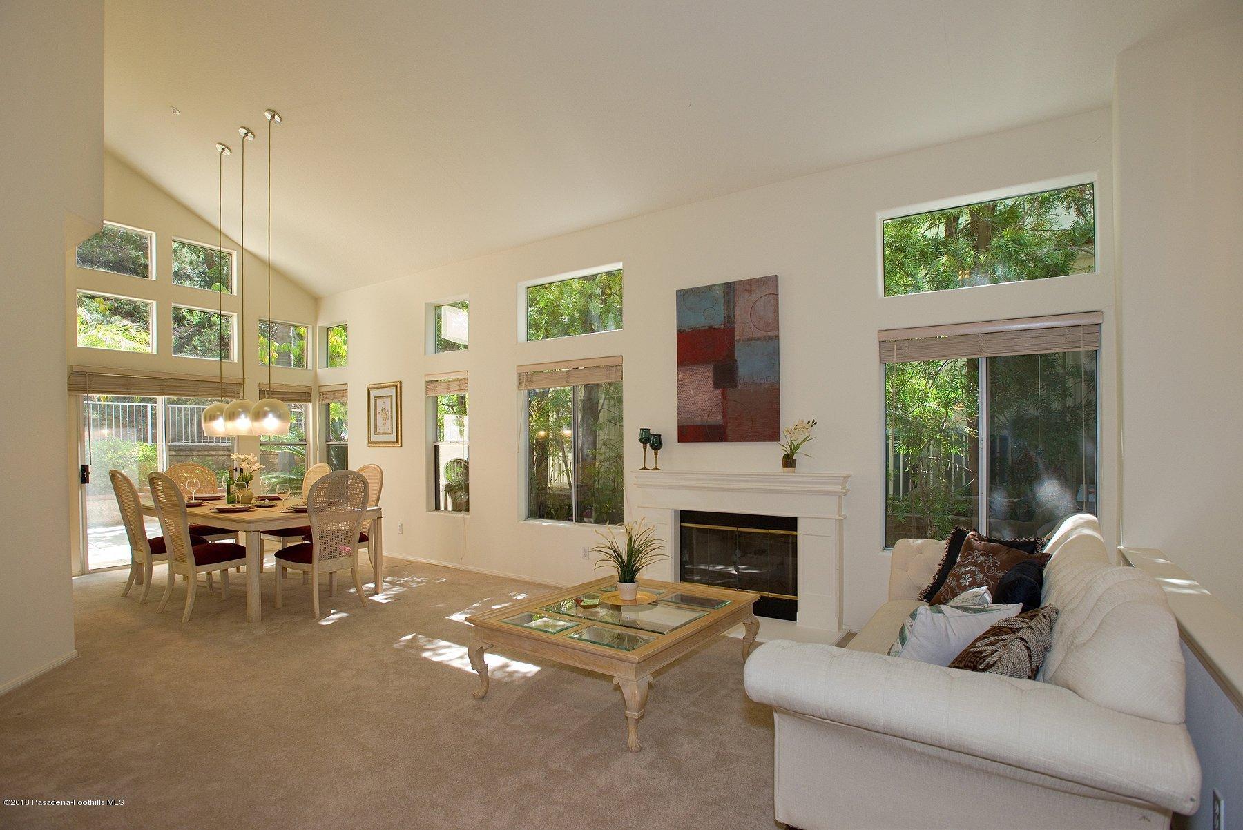 925 C. Amable Glendale, CA 91208 - Photo 8 of 37 a living room with furniture a large window and a fireplace