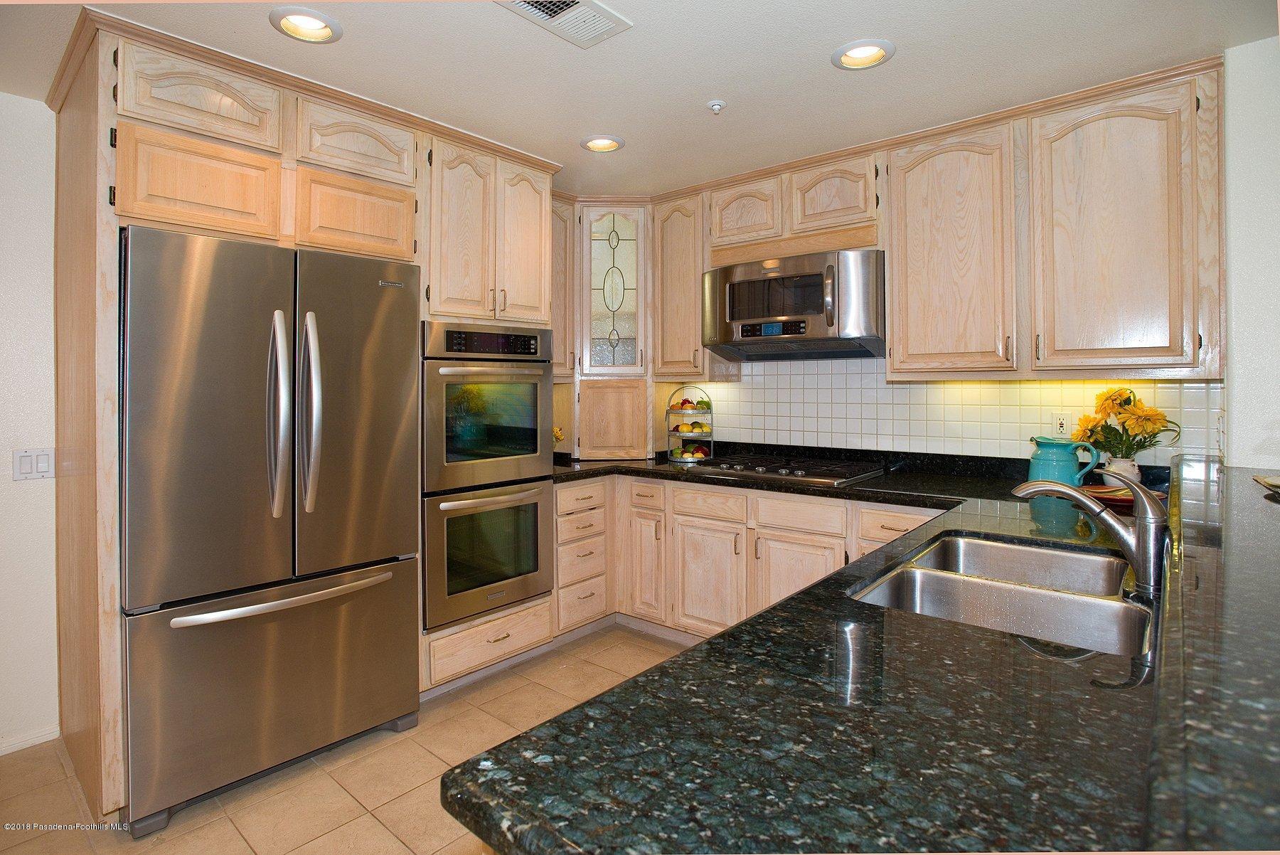 925 C. Amable Glendale, CA 91208 - Photo 9 of 37 a kitchen with stainless steel appliances granite countertop a refrigerator a stove top oven a sink and dishwasher