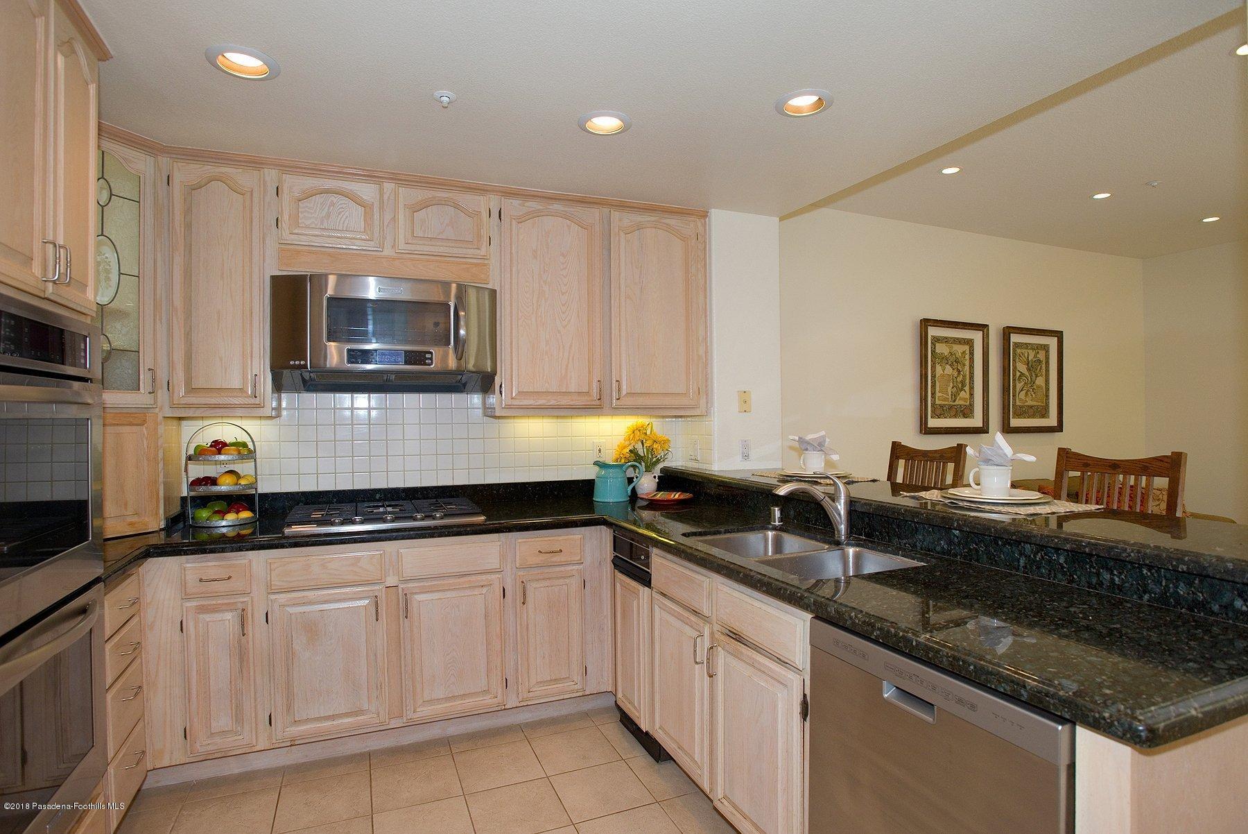925 C. Amable Glendale, CA 91208 - Photo 10 of 37 a kitchen with granite countertop white cabinets white appliances and granite counter tops
