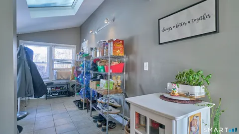 a bathroom with a granite countertop sink toilet and mirror