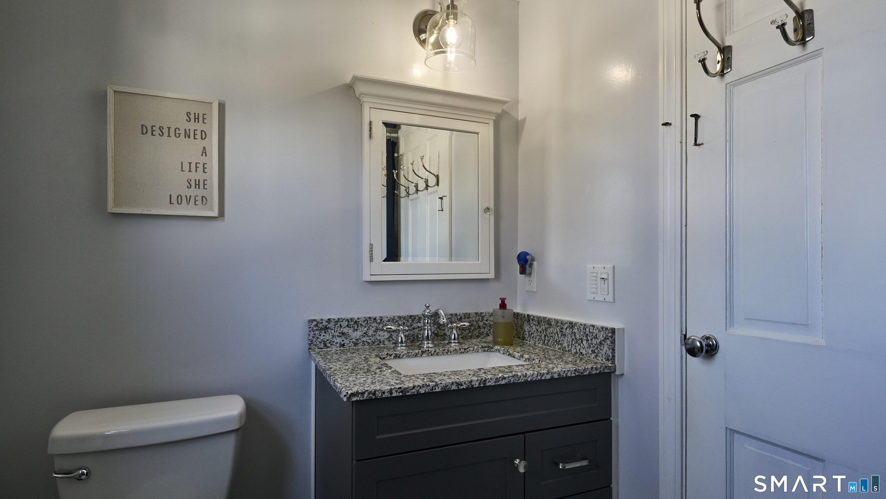 342 South Main Street West Hartford, CT 06107 - Photo 18 of 36 a bathroom with a granite countertop sink toilet and mirror