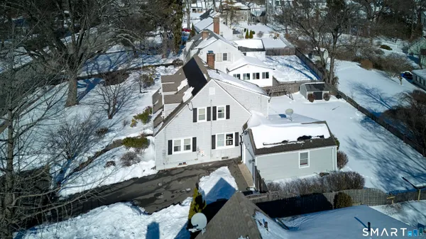 a view of a house with a yard covered with snow in the background