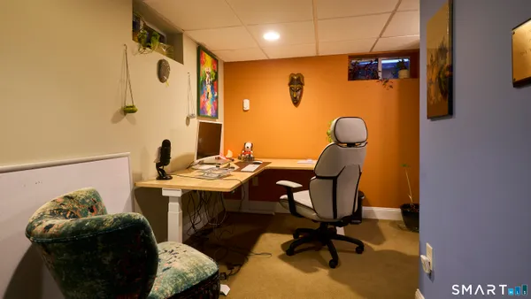 a view of a livingroom with furniture and a ceiling fan