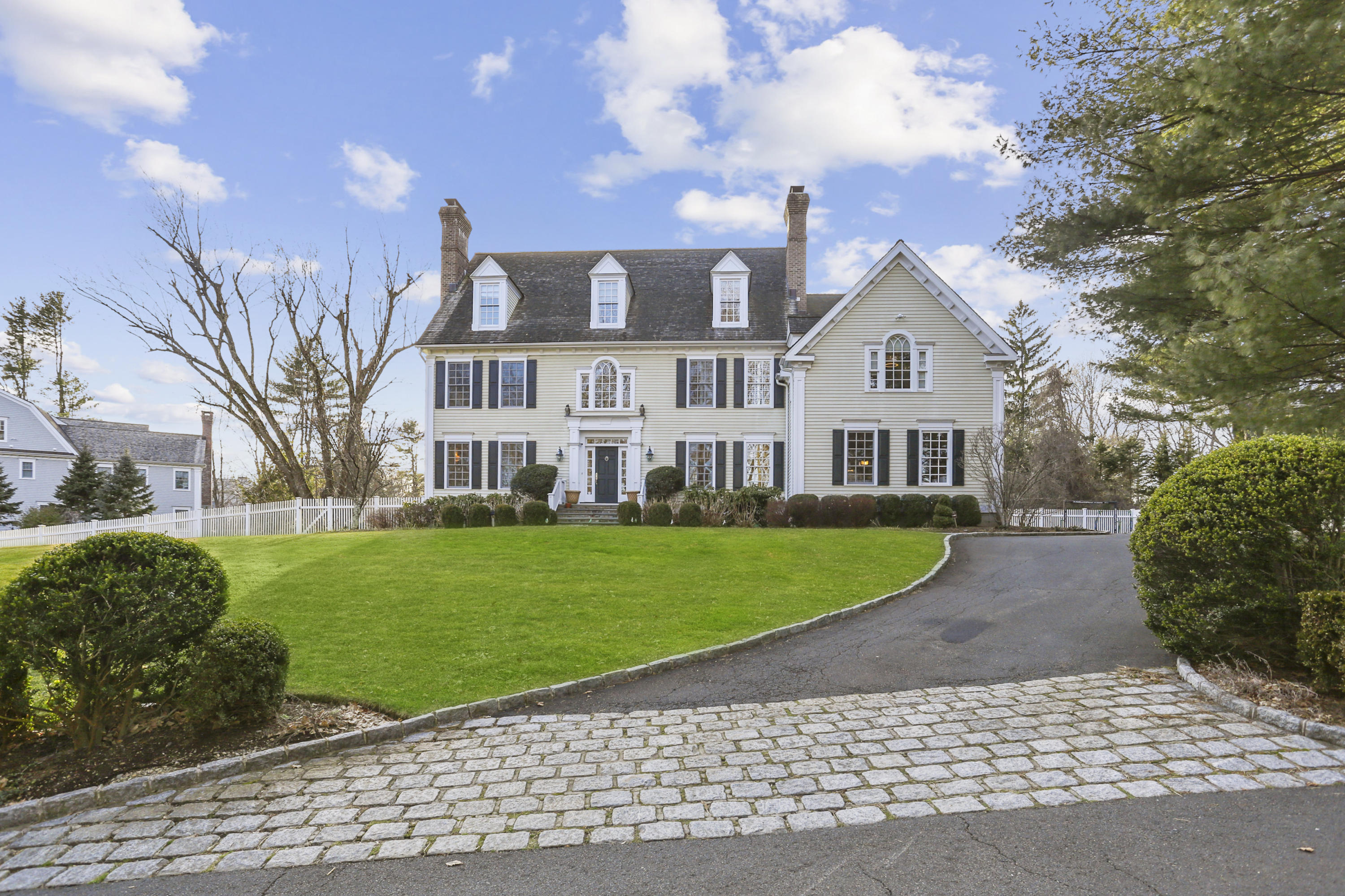 a front view of a house with a garden and yard