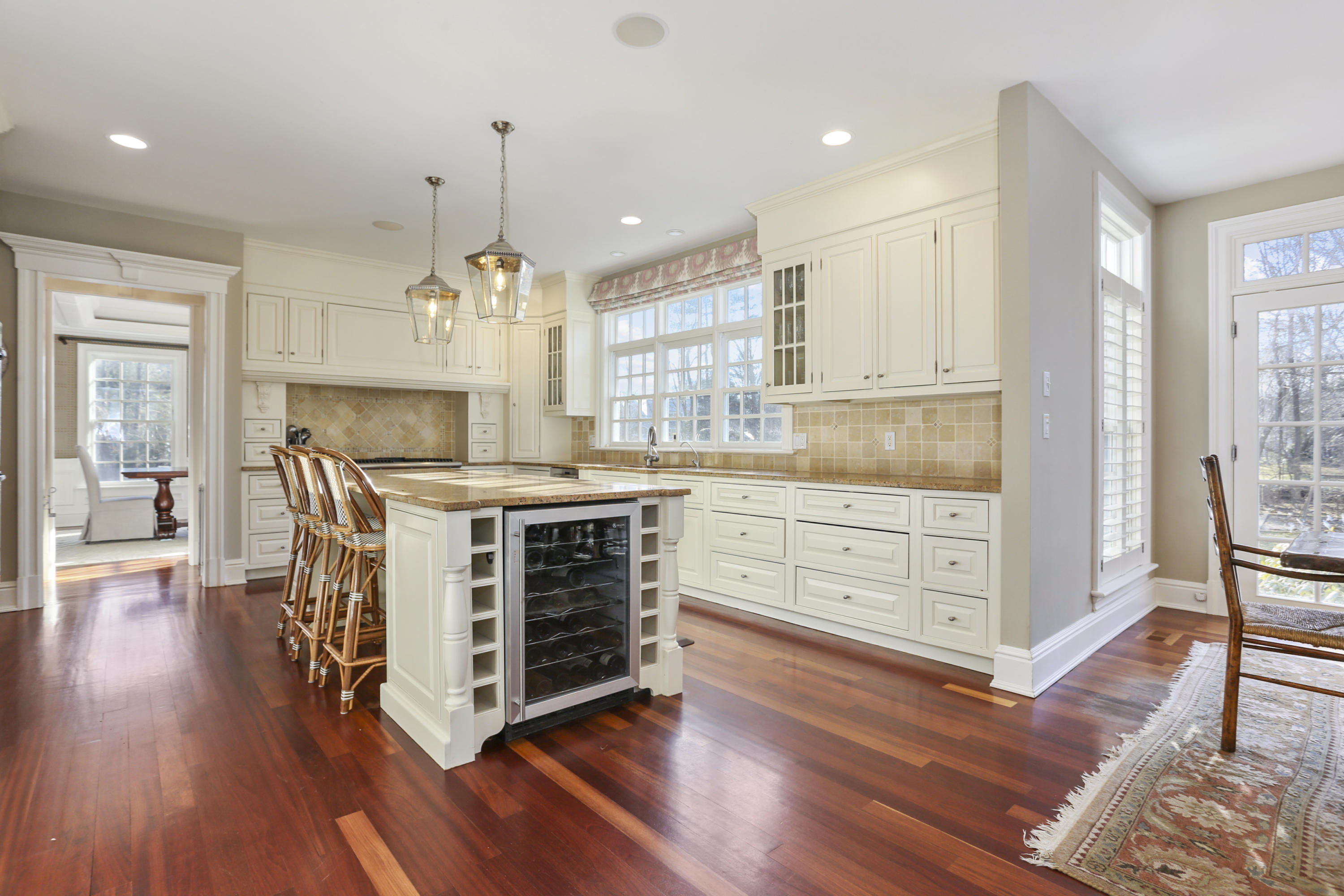 364 Smith Ridge Road New Canaan, CT 06840 - Photo 11 of 39 a kitchen with kitchen island granite countertop a stove cabinets and wooden floor