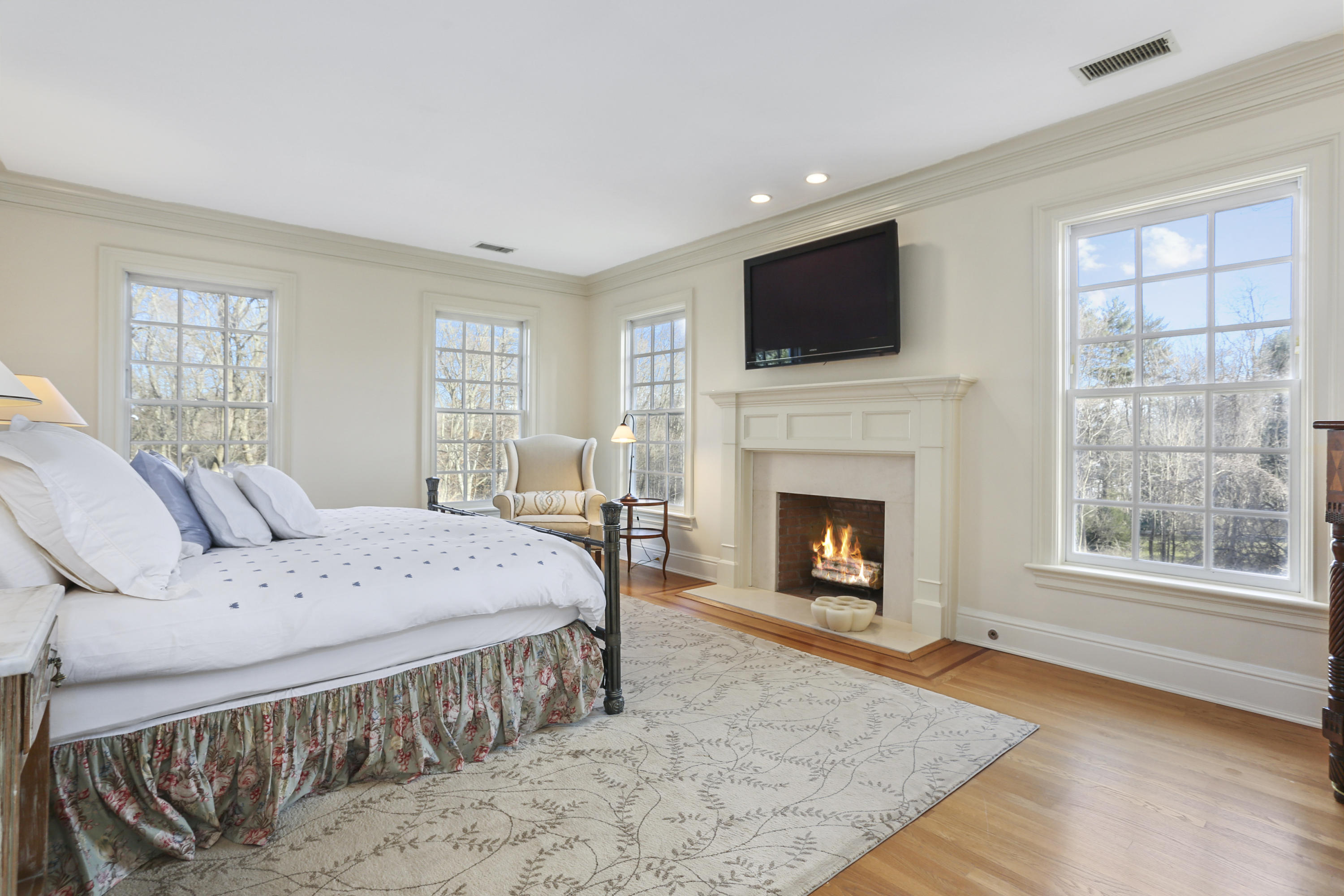 364 Smith Ridge Road New Canaan, CT 06840 - Photo 21 of 39 a spacious bedroom with a bed and a fireplace