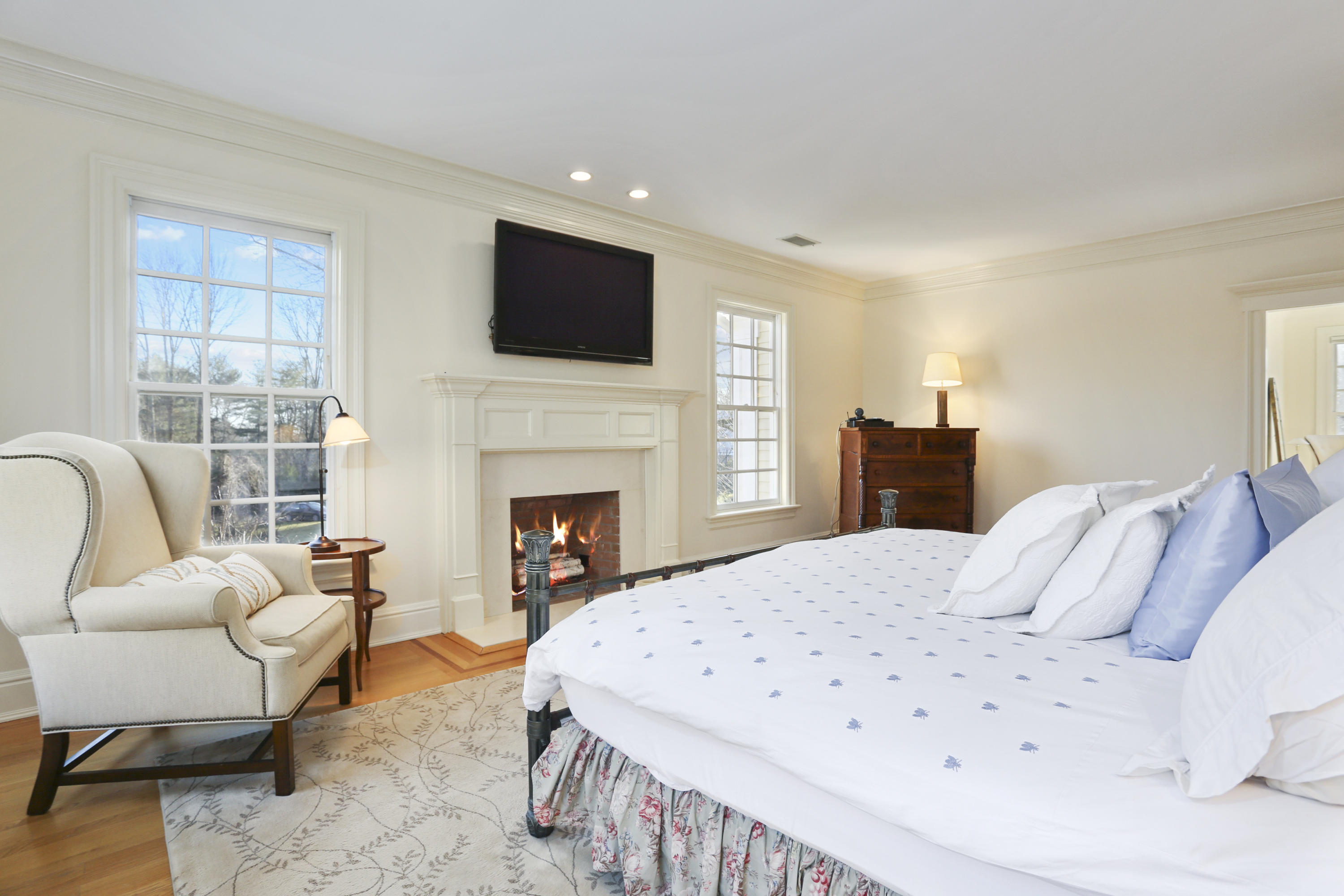 364 Smith Ridge Road New Canaan, CT 06840 - Photo 22 of 39 a living room with furniture a fireplace and a flat screen tv
