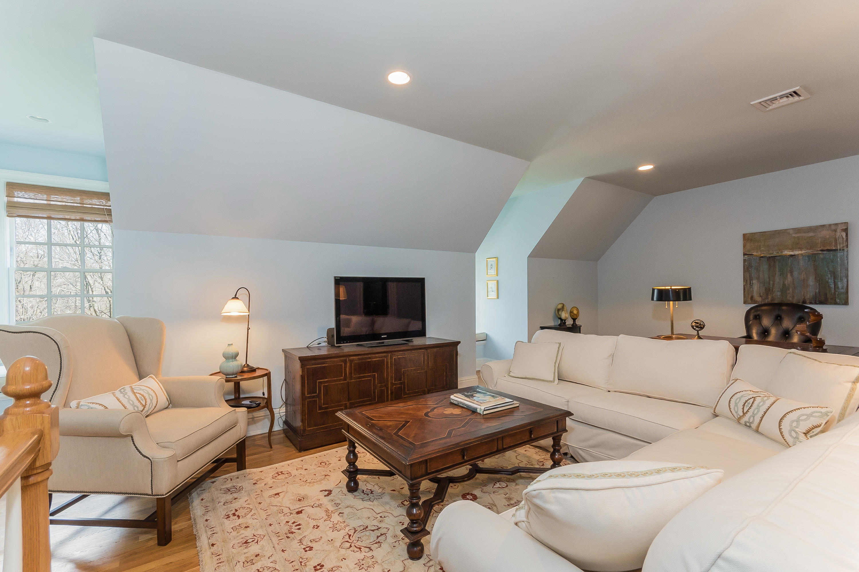 364 Smith Ridge Road New Canaan, CT 06840 - Photo 30 of 39 a living room with furniture a rug and a flat screen tv