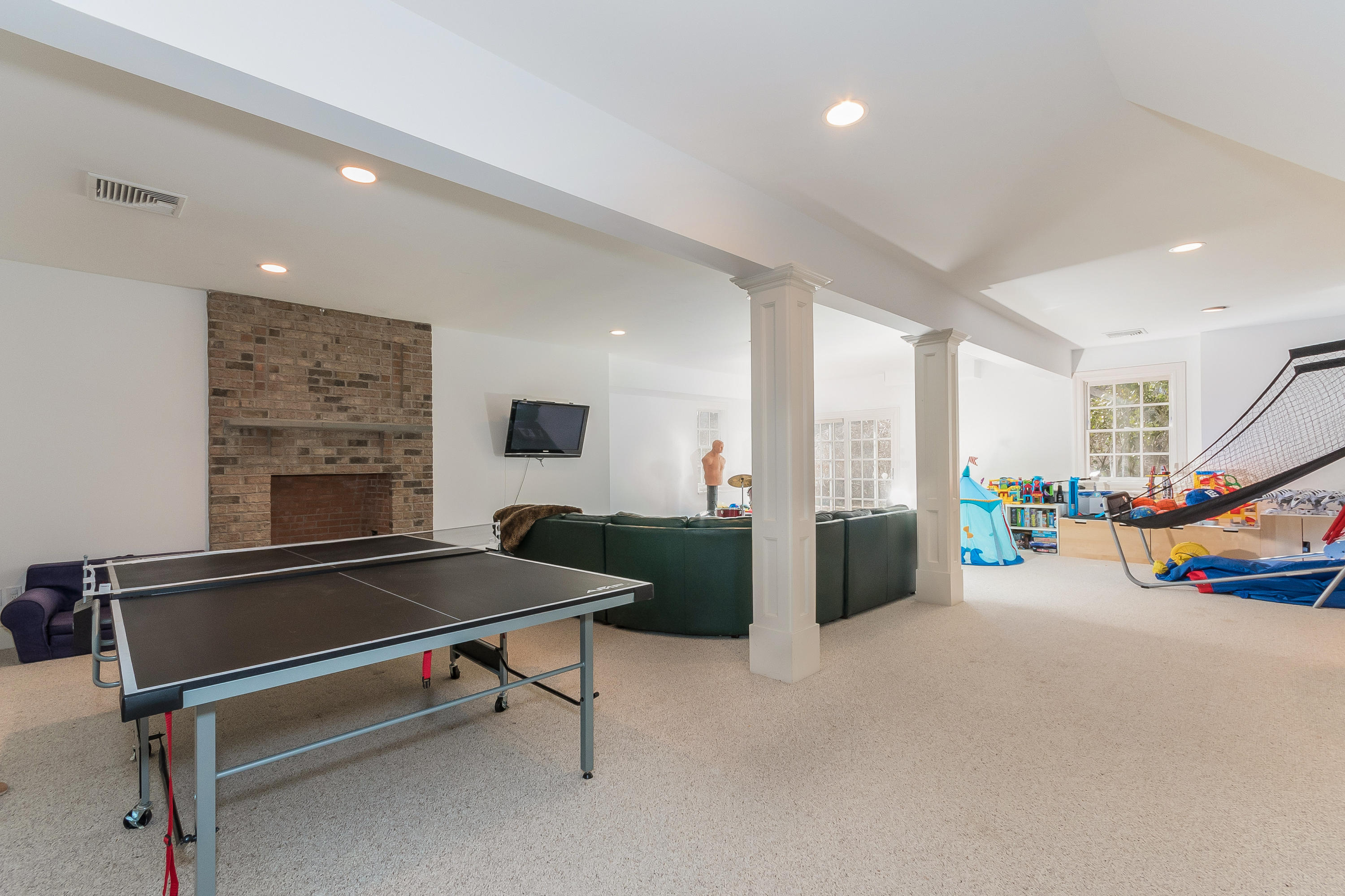364 Smith Ridge Road New Canaan, CT 06840 - Photo 32 of 39 a living room with furniture pool table and a fireplace