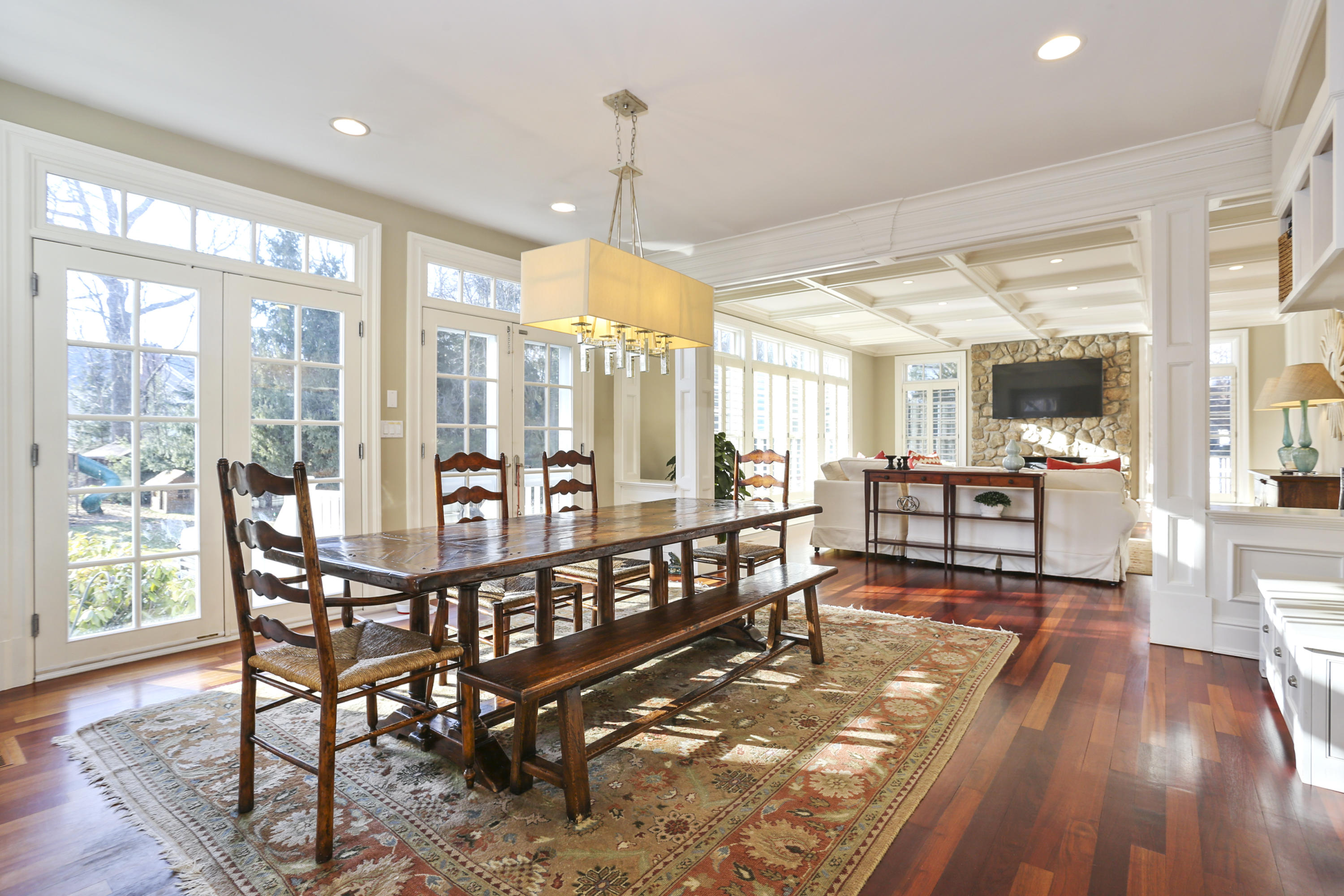 364 Smith Ridge Road New Canaan, CT 06840 - Photo 8 of 39 a dining room with furniture a chandelier and wooden floor