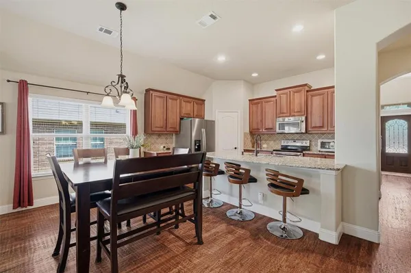 a view of a dining room with furniture and wooden floor