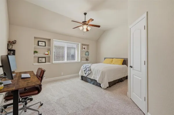 a spacious bedroom with a bed and a couch