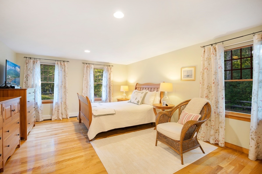 46 Oak Street Barnstable, MA 02635 - Photo 13 of 40 a spacious bedroom with a bed and wooden floor