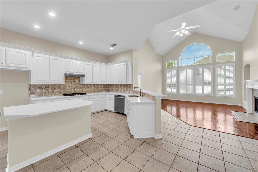 3920 Autumn Lane Bedford, TX 76021 - Photo 12 of 36 Open-concept kitchen and living area featuring a vaulted ceiling and wood-finish flooring