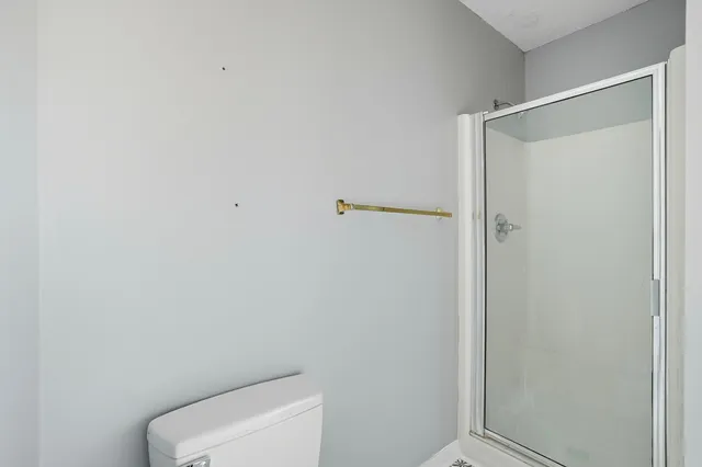 a bathroom with a toilet and a shower