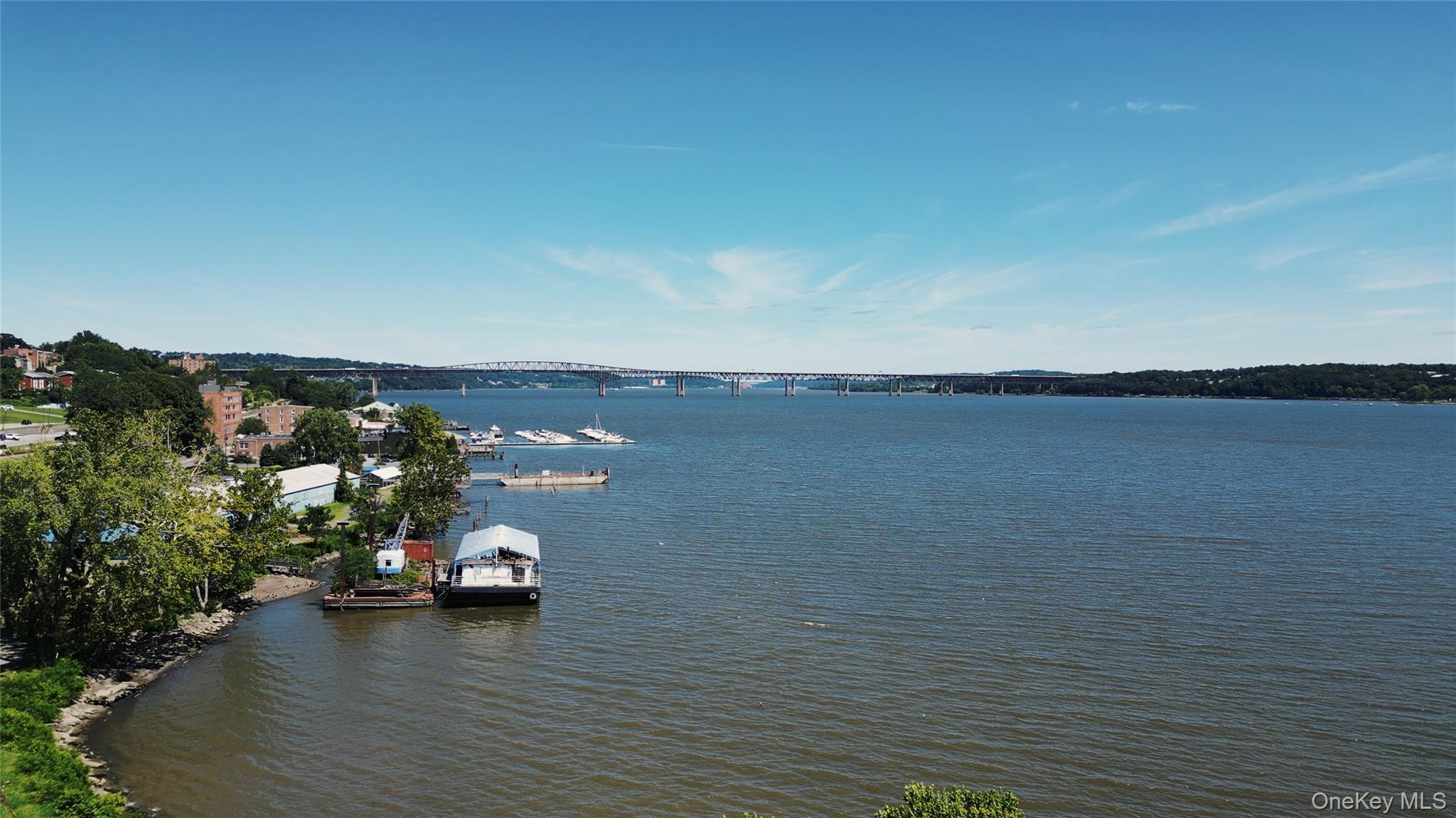Water view with a notable bridge and a dock