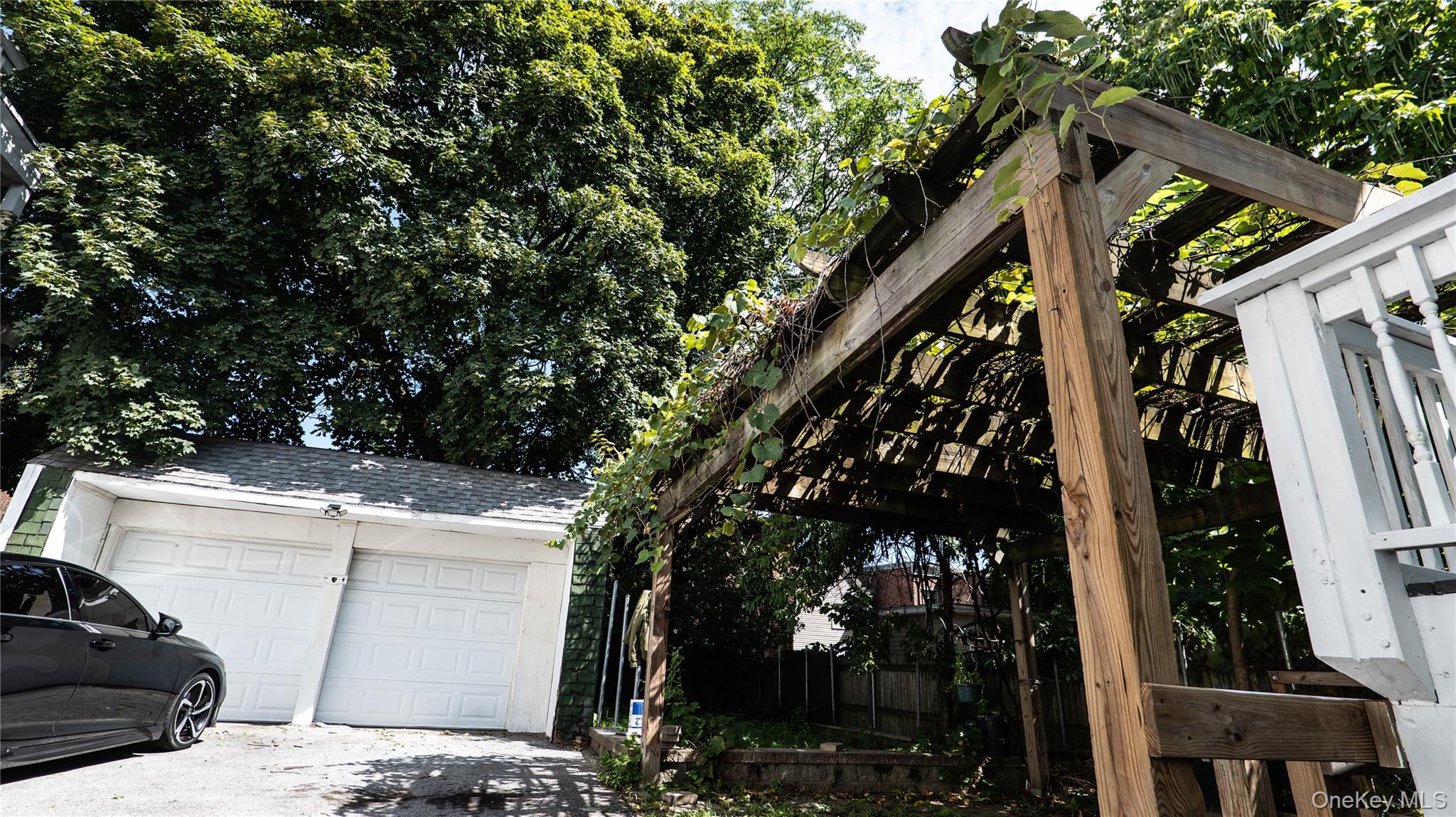 52 Beacon Street Newburgh, NY 12550 - Photo 3 of 12 View of side of home featuring an outdoor structure, a garage, and a shingled roof