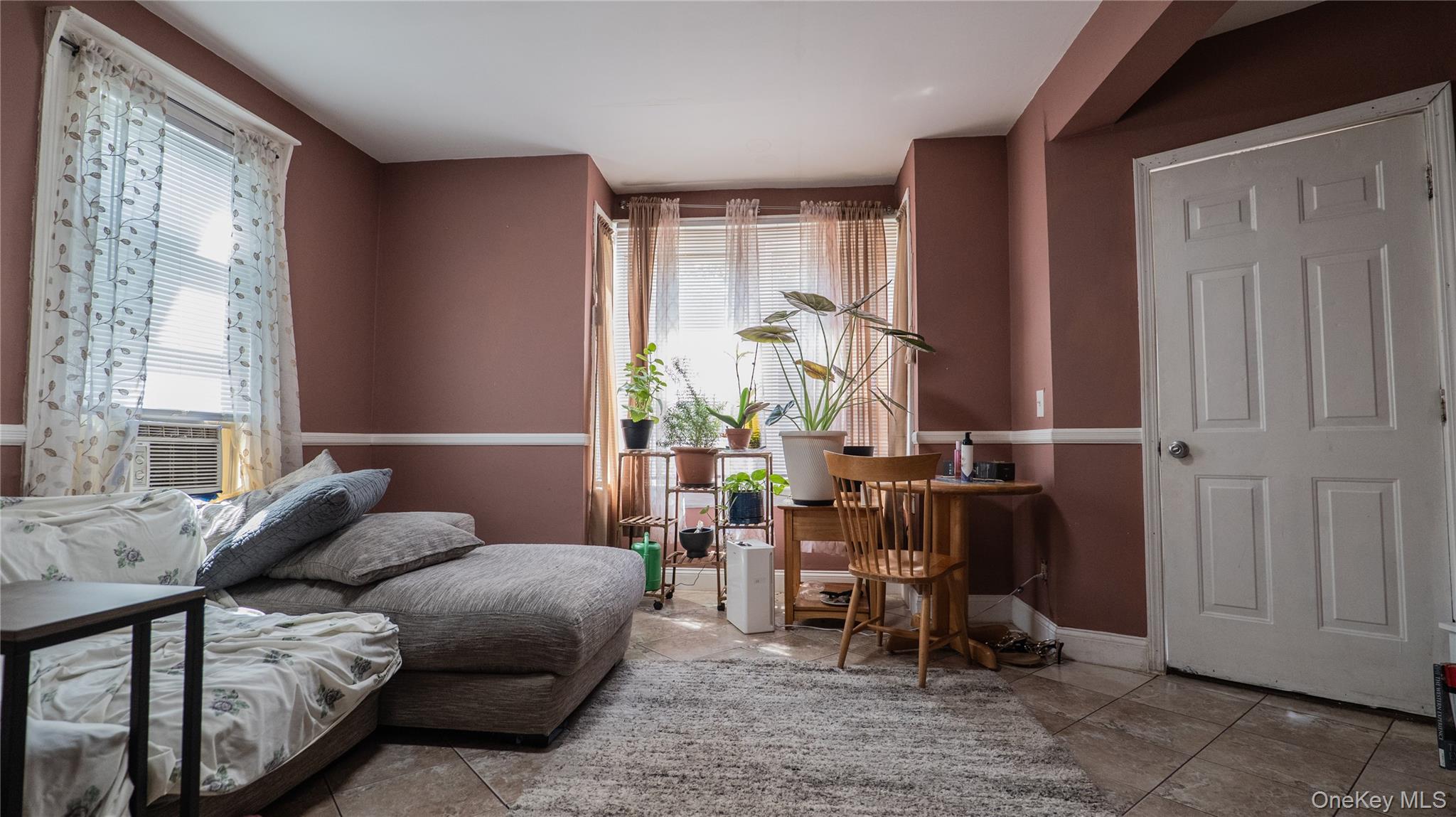 52 Beacon Street Newburgh, NY 12550 - Photo 4 of 12 Living area with plenty of natural light, tile patterned flooring, and cooling unit
