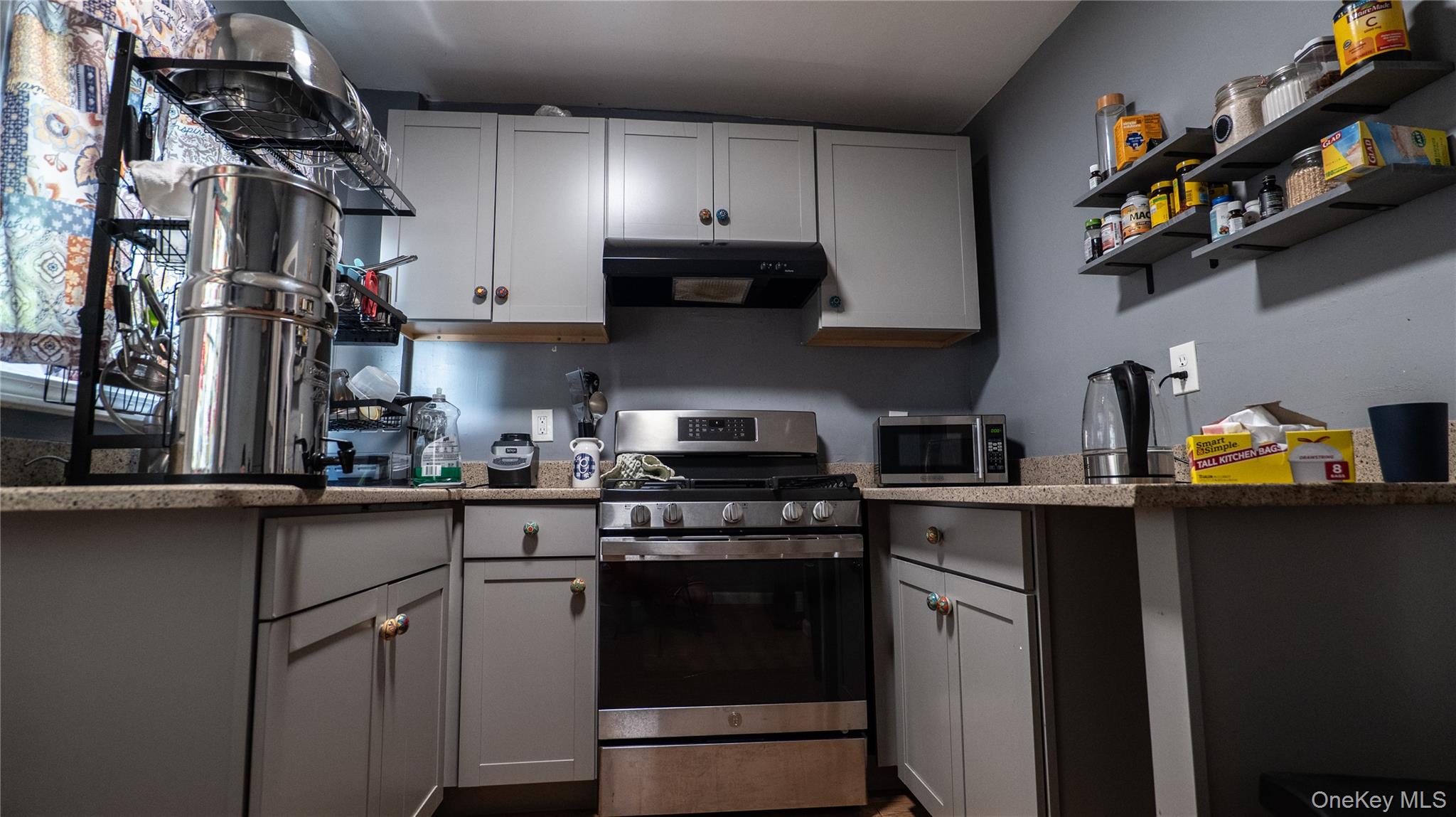 52 Beacon Street Newburgh, NY 12550 - Photo 7 of 12 Kitchen featuring appliances with stainless steel finishes, gray cabinets, and exhaust hood
