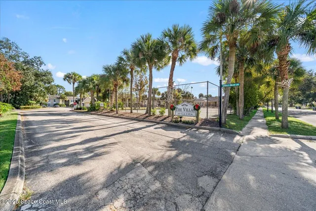 a backyard of apartments with large trees