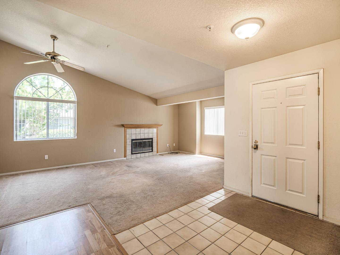 313 Sombra Watsonville, CA 95076 - Photo 14 of 37 an empty room with windows and chandelier fan