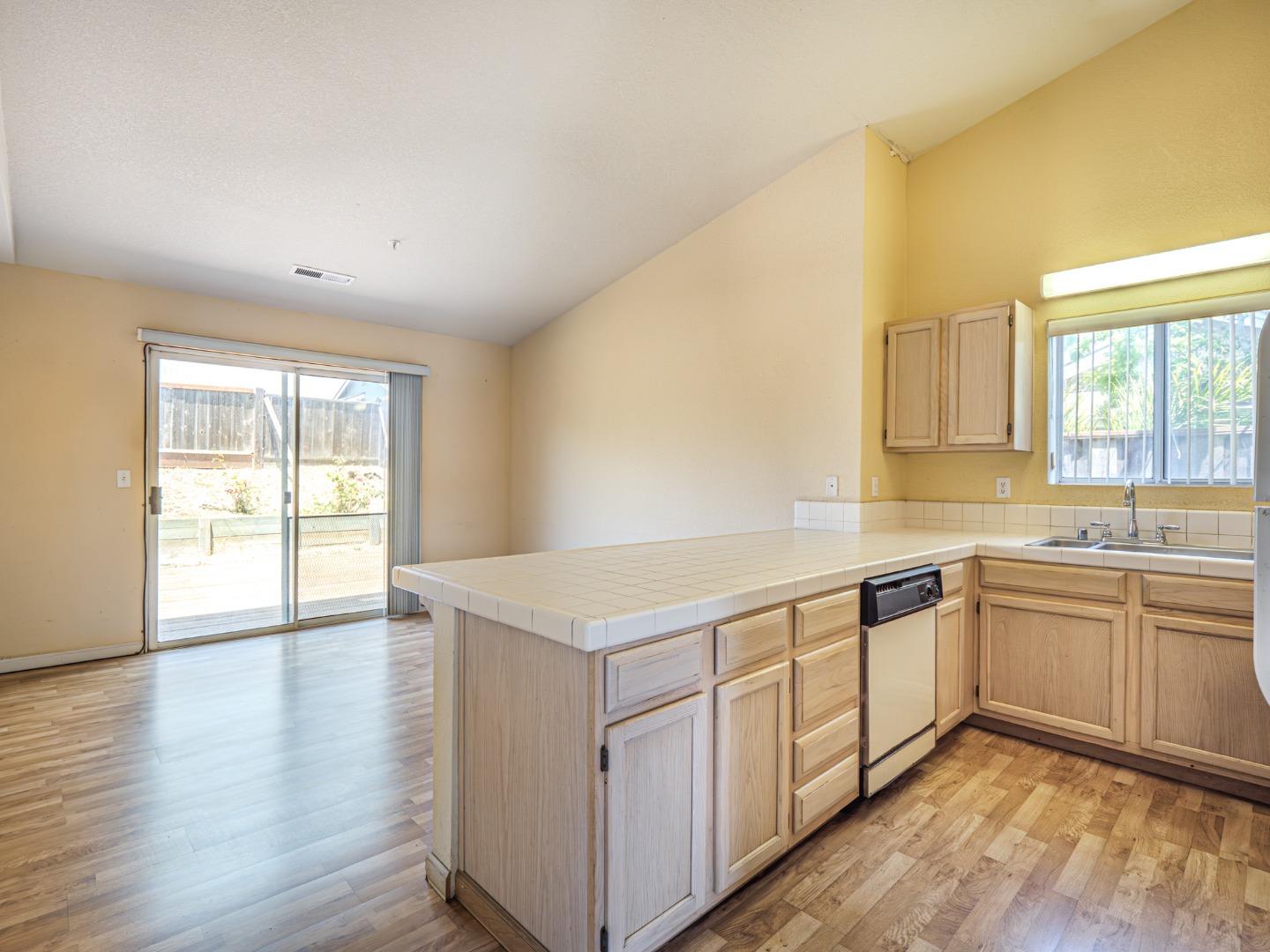 313 Sombra Watsonville, CA 95076 - Photo 20 of 37 a view of a kitchen with wooden floor and electronic appliances