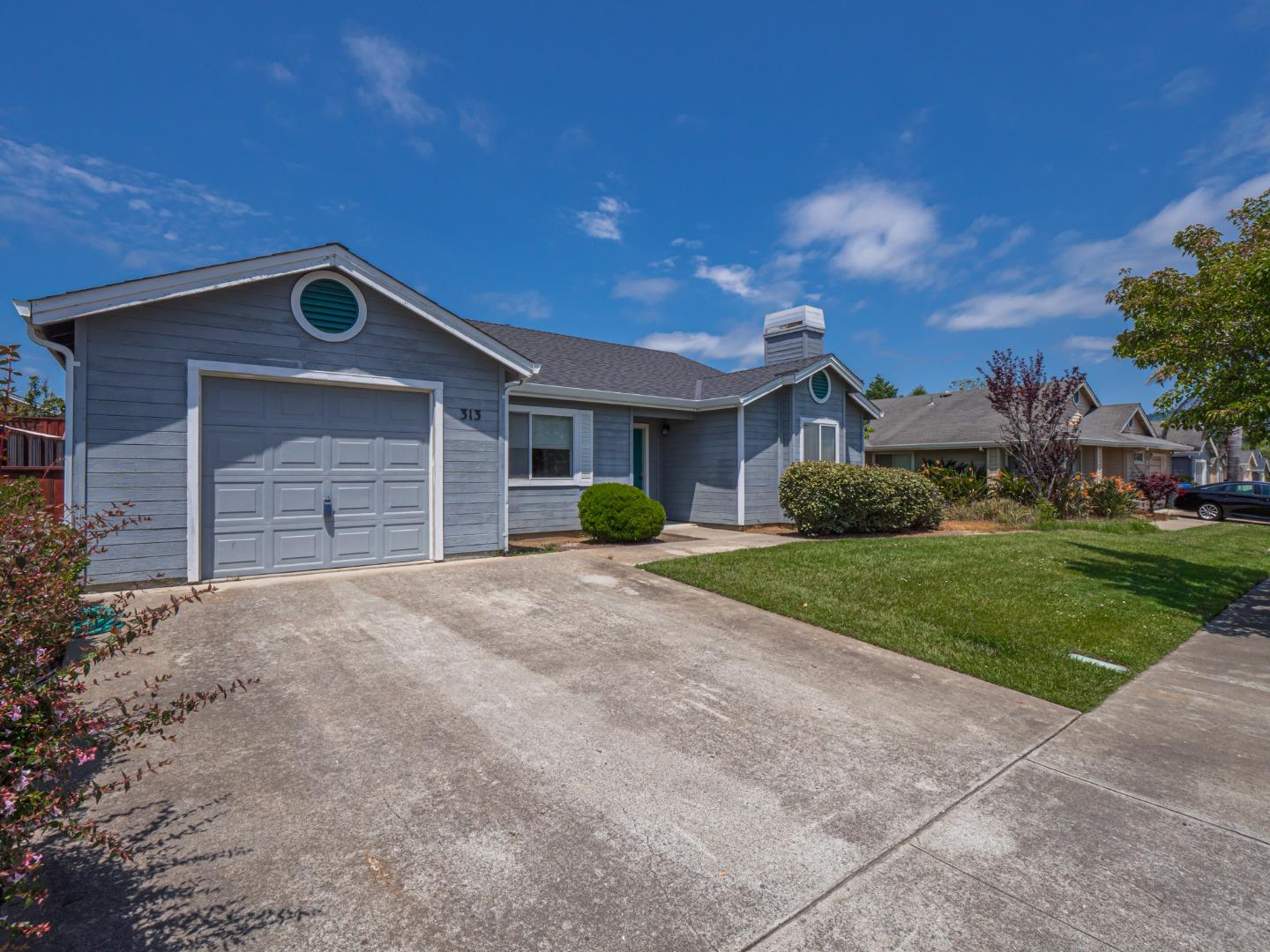 313 Sombra Watsonville, CA 95076 - Photo 2 of 37 a front view of a house with a yard and garage
