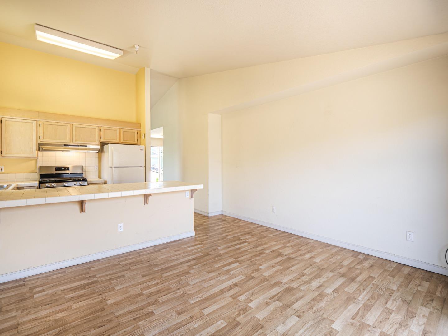 313 Sombra Watsonville, CA 95076 - Photo 22 of 37 a view of a kitchen with wooden floor and a window