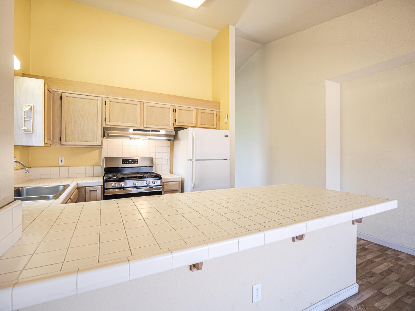 313 Sombra Watsonville, CA 95076 - Photo 23 of 37 a kitchen with a sink stove and cabinets