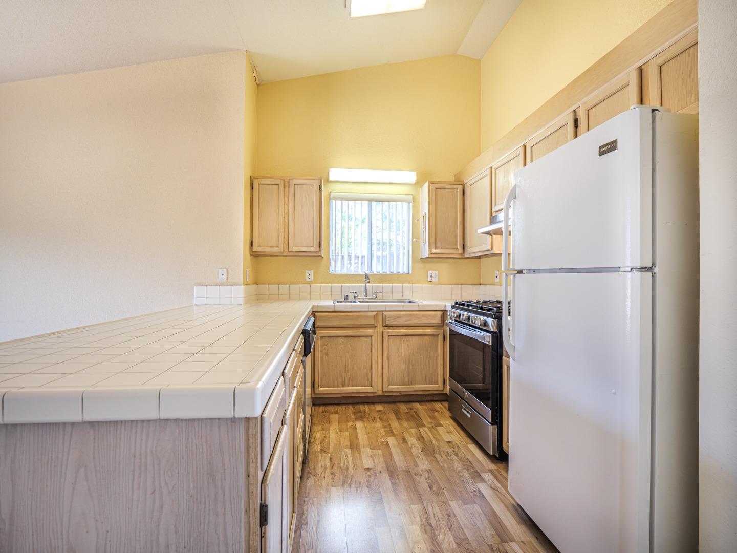 313 Sombra Watsonville, CA 95076 - Photo 25 of 37 a kitchen with a refrigerator a sink and dishwasher