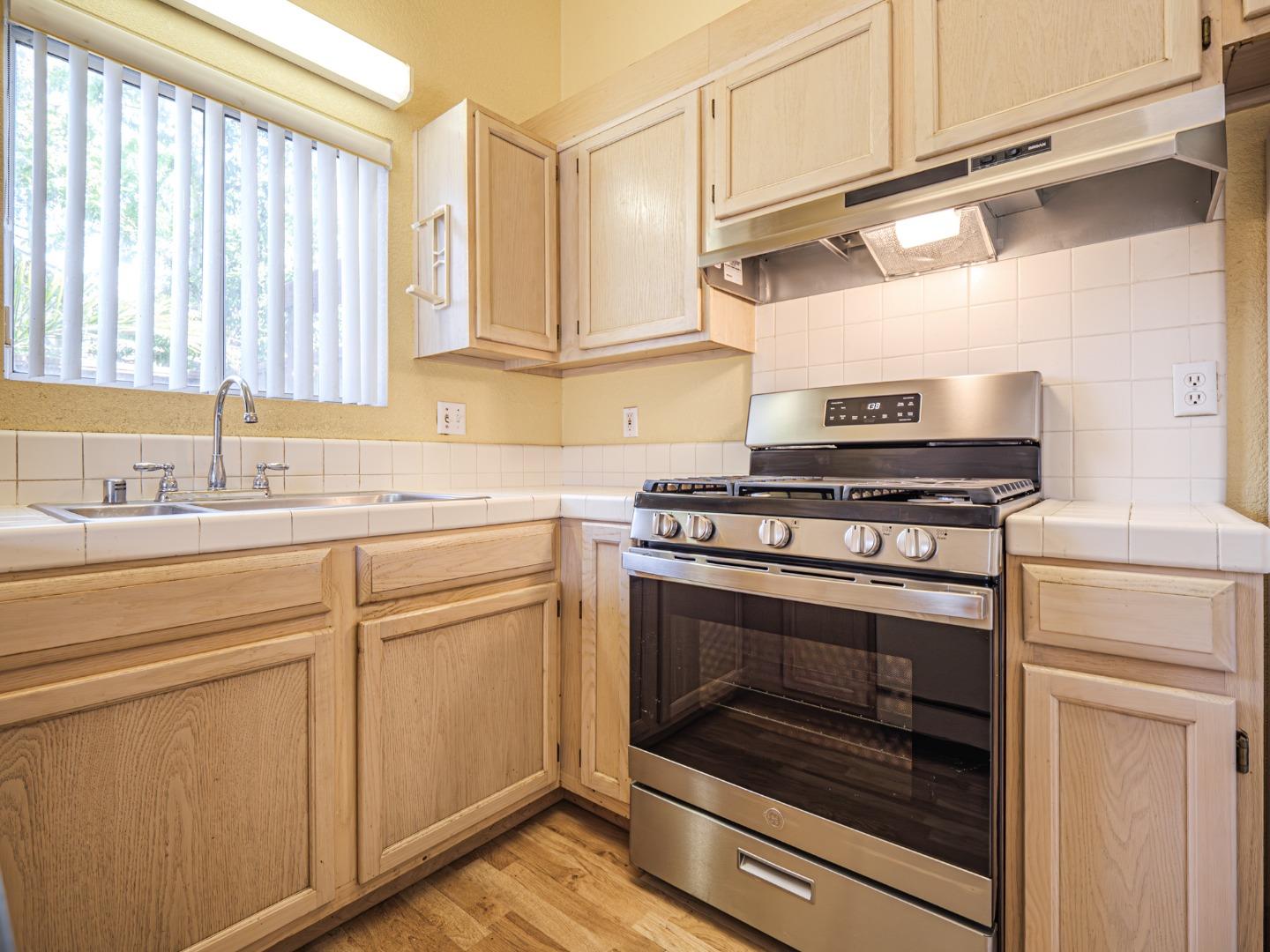 313 Sombra Watsonville, CA 95076 - Photo 26 of 37 a kitchen with stainless steel appliances white cabinets and a stove a sink