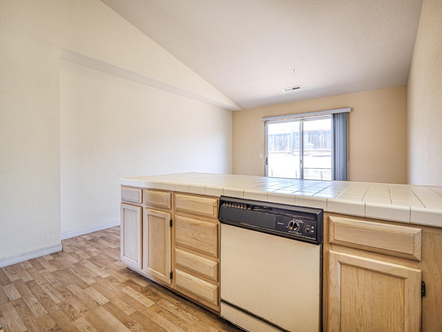313 Sombra Watsonville, CA 95076 - Photo 27 of 37 a kitchen with granite countertop white cabinets and white appliances