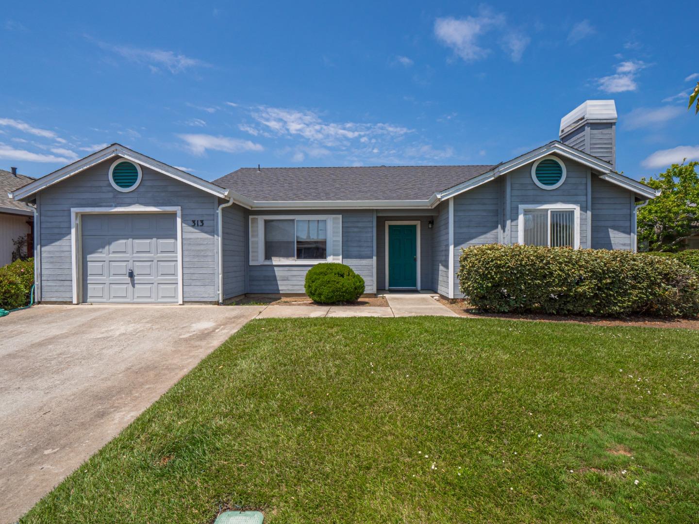 313 Sombra Watsonville, CA 95076 - Photo 3 of 37 a front view of a house with a yard and garage
