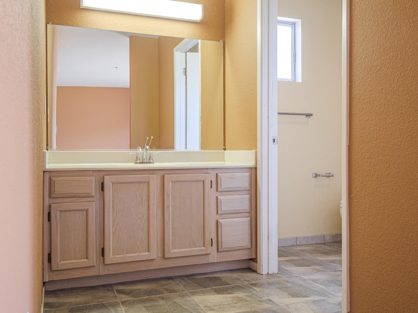 313 Sombra Watsonville, CA 95076 - Photo 31 of 37 a bathroom with a sink and a mirror